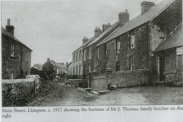 Copy of a photograph of Main Street Llangwm Pembrokeshire c 1917 showing the business of Mr J Thomas family butcher on the right
